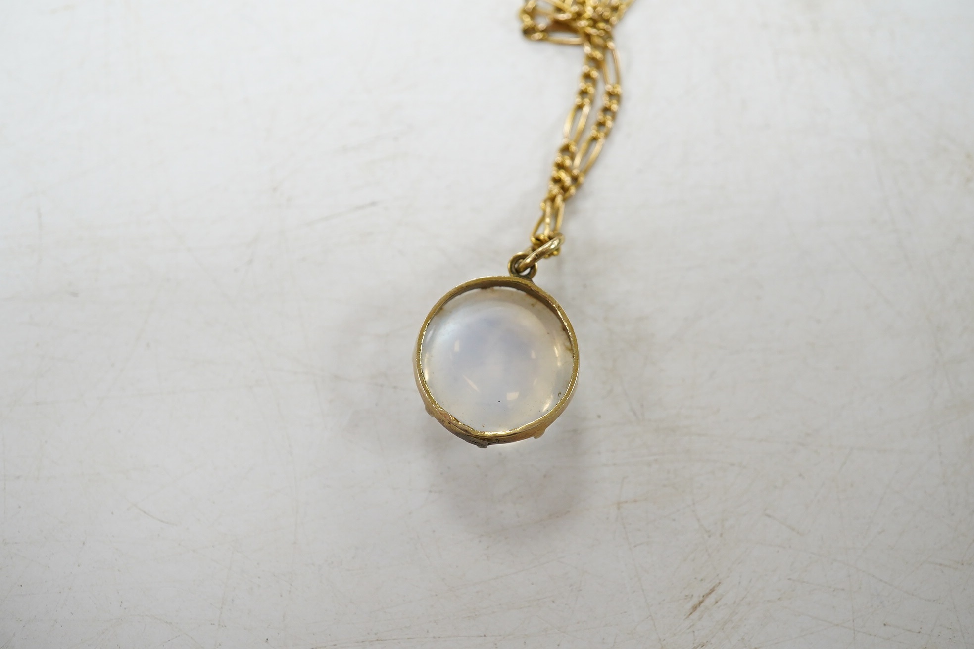 A yellow metal and single stone cabochon moonstone set pendant necklace, overall 42cm, gross weight 5.1 grams. Condition - fair